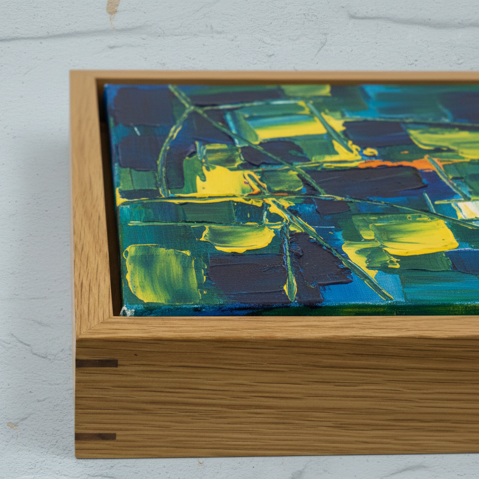 Abstract painting with a wooden frame on a light gray background